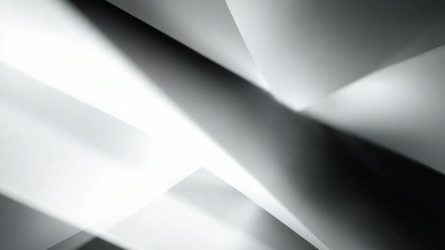 Abstract geometric shapes in grayscale with dramatic lighting. The interplay of light and shadow creates a visually compelling and minimalist aesthetic.