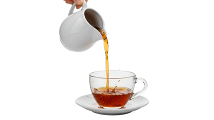 White teapot pouring tea into a clear glass cup on a saucer