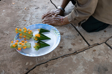 An old Laotian man prostrating for blessings at the Buddhist temple.