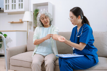 senior woman doing exercise at clinic with physiotherapist. help of a personal trainer during a...