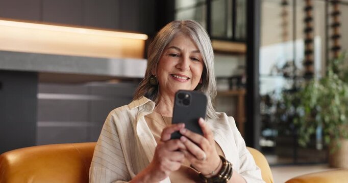 Couch, reading or senior woman with phone in home, social media or check message notification. Watch video, pensioner blog or old person smile for retirement forum post, relax or browsing internet
