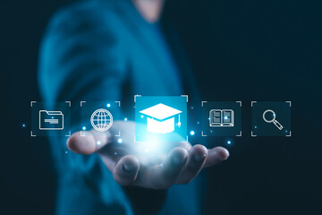 Digital education concept with graduation cap icon floating above human hand, representing online learning, e-learning platform, knowledge management, digital library, and modern education technology.