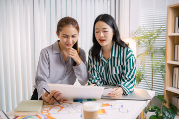 UX/UI designers presenting their final design project to the team, showcasing app interface screens and explaining user experience strategies in a professional creative office environment.