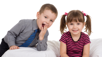 Smiling girl with pink bows and boy with hand to mouth