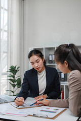 Businesswomen discussing financial data during office meeting