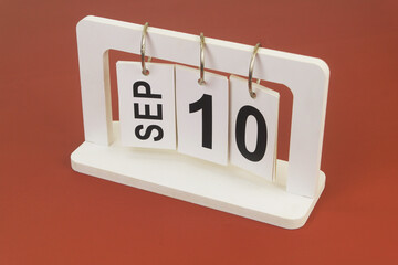September 10 on calendar on brown background