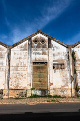 Facade of an old industrial warehouse that is next to an abandoned railway, on the little city in Brazil