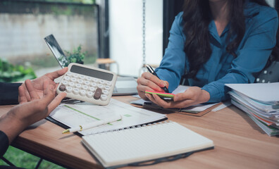 Financial Consultation: A close-up shot captures the focused collaboration between a financial advisor and their client, as they engage in a productive consultation at a desk.