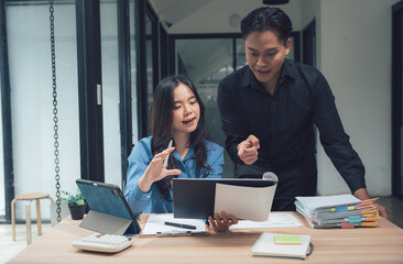 Collaborative Synergy in the Office: A man and woman in an office setting engage in an intimate discussion. This image exudes professional collaboration, showcasing teamwork, focus.