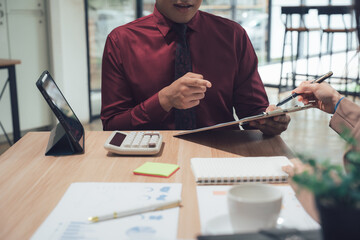 Business Collaboration: Focused individuals collaborate at a desk.