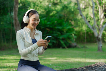 Woman enjoying music using phone in park