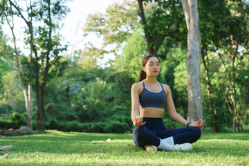 Young woman meditating in lotus pose outdoor