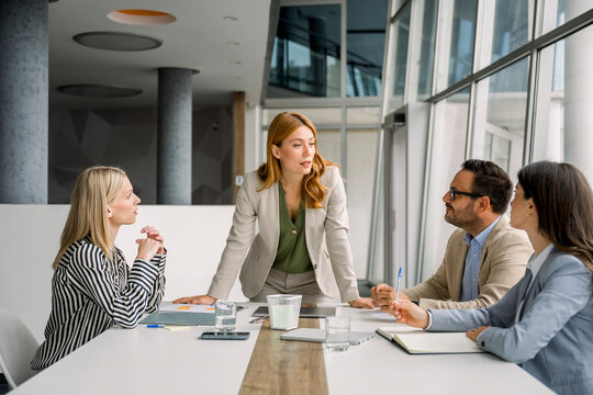 Business team working and discussing in modern office meeting