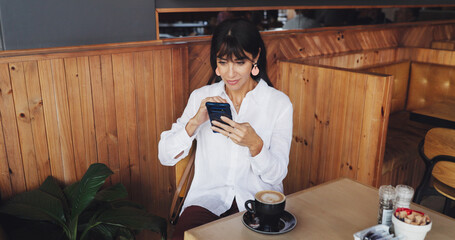 Business woman, phone and scroll in coffee shop for break, social media or remote work. Mature freelancer, research and tech with internet for article, website or review in cafe for notification