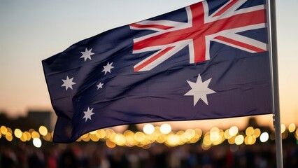 Australian flag waving at sunset over blurred crowd