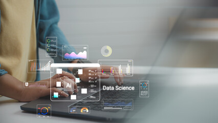 Close up of hand using laptop with AI Analysis digital brain hologram and data interface, representing artificial intelligence technology and machine learning in modern office workspace.