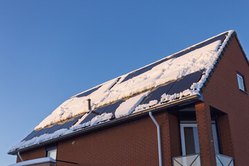 Residential house with solar panels on a snow covered roof in winter, combining renewable energy, sustainability and cold seasonal weather conditions. Utrecht Netherlands, 5 january 2026