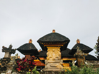 Balinese temple shrines with tiered thatched roofs