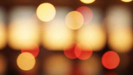 Abstract warm-toned bokeh of orange and red lights in soft focus against dark