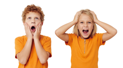 Shocked young boy and screaming girl expressing intense emotions in a studio portrait