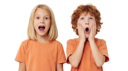 Close-up studio portrait of two young children, a boy and girl, expressing shock.