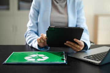 Corporate sustainability and recycling management concept with ESG reporting, green office workflow, digital tablet, and environmental responsibility
