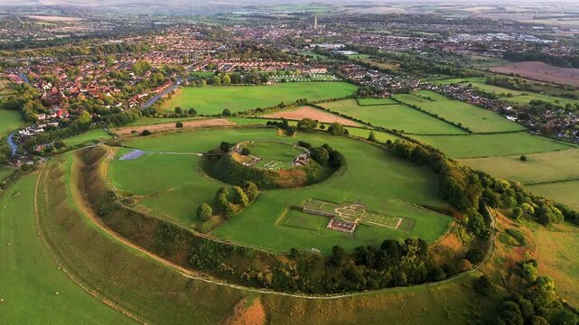 Old Sarum, Salisbury, dates from 3000 BC Neolithic. Shows Iron Age hillfort, Norman central motte and bailey and cathedral ruin. Salisbury city behind. Video static