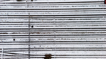 Railway lines, train tracks covered with snow aerial drone view, railway in the Netherlands in winter, transport disruption due to winter weather problems and heavy snow