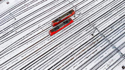 Railway lines, train tracks covered with snow aerial drone view, railway in the Netherlands in winter, transport disruption due to winter weather problems and heavy snow
