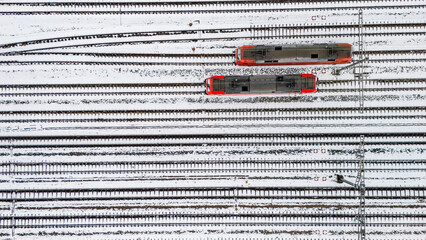 Railway lines, train tracks covered with snow aerial drone view, railway in the Netherlands in winter, transport disruption due to winter weather problems and heavy snow