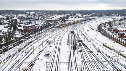 Railway lines, train tracks covered with snow aerial drone view, railway in the Netherlands in winter, transport disruption due to winter weather problems and heavy snow