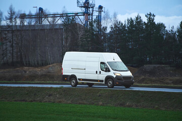Delivery van driving along countryside road