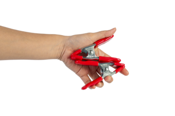 A studio shot of a red stainless spring clamp in hand isolated on a transparent background