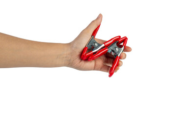 A studio shot of a red stainless spring clamp in hand isolated on a transparent background
