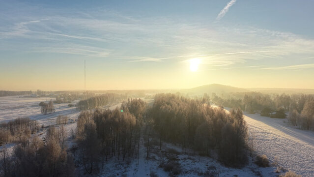 Aerial view of snowy forest at sunrise - Powered by Adobe