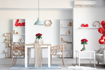 Interior of room decorated for Valentine's Day with tables and roses in vases