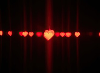 Glowing red heart ornaments on dark background