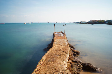 Concrete bridge walking down this path into calm sea