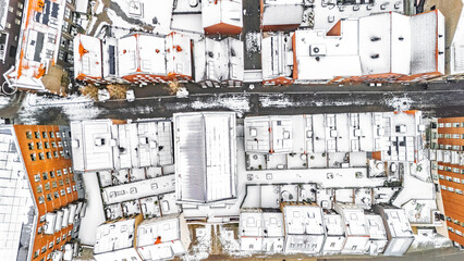 Aerial drone view of houses roofs covered with snow, residential area neighborhood and town streets in snowy winter weather, Venlo city, the Netherlands