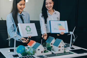 Hands of adult Asian business professionals analyzing ESG financial data and renewable energy project plans