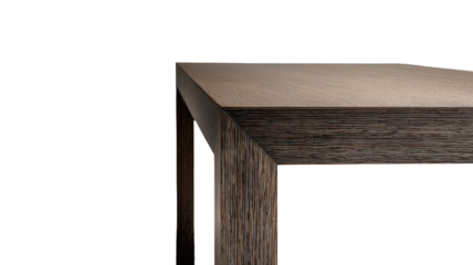 Close-up of wood table corner, showing edge detail, on black background
