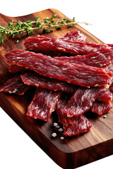 Jerky strips and thyme sprig on wooden board with salt crystals
