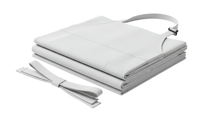 A stack of folded aprons with straps, crisp white on a black background