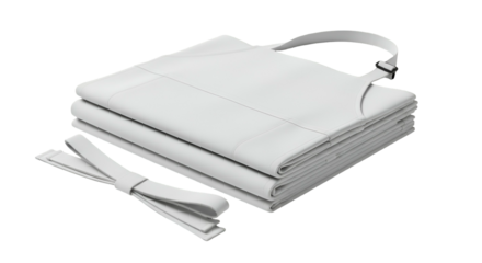 A stack of folded aprons with straps, crisp white on a black background