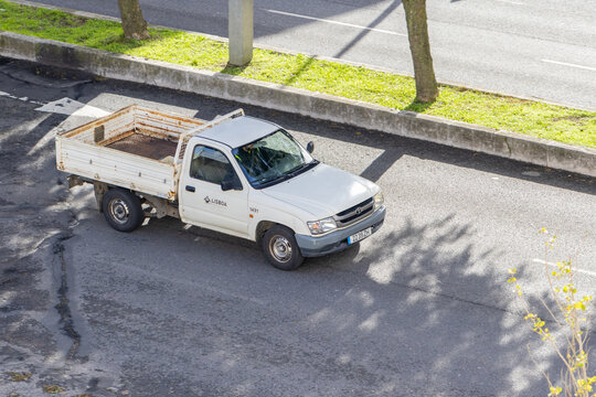 White toyota hilux parked on sunny lisbon street