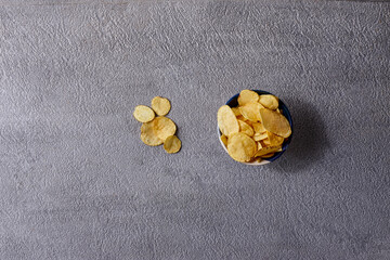Assorted snacks in pottery bowls on grey background