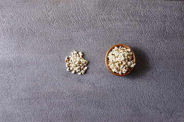 Assorted snacks in pottery bowls on grey background