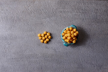 Assorted snacks in pottery bowls on grey background