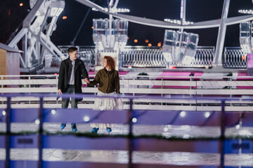 Couple enjoying ice skating on a romantic night date