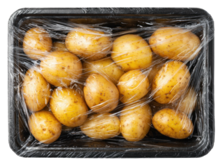 Potatoes in plastic wrap within black tray, shot from above